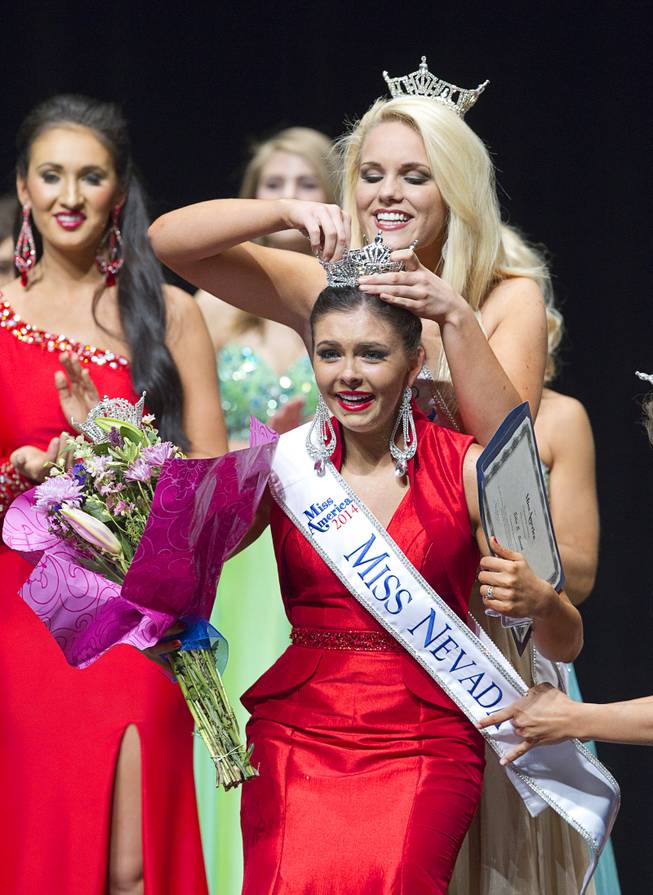 Ellie Smith of Henderson reacts as she is crowned 2014 Miss Nevada by 2013 Miss Nevada Diana Sweeney at the Miss Nevada and Miss Nevada Outstanding Teen Pageant at the Las Vegas Academy Theater Sunday, June 1, 2014. Her sister Amy Smith was crowned 2014 Miss Nevada Outstanding Teen.