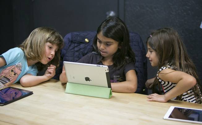 From left, Anna Heath, 5; Aryka Gunsagar, 6; and Rayah Ghosheh, 6, test Kidaptive's Leo's Pad app at the Kidaptive office in Palo Alto, Calif., May 7, 2014.