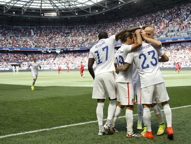 United States' Fabian Johnson (23) is congratulated by teammates after scoring a goal against Turkey in the first half of an international friendly soccer match on Sunday, June 1, 2014, in Harrison, N.J. The U.S. won 2-1.