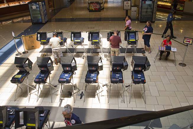 Voters cast their ballots during early voting at the Meadows Mall on Monday, June 2, 2014.