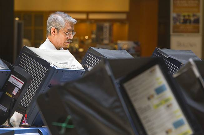 Sergio Rueda, 61, votes at the Meadows Mall Monday, June 2, 2014. Early voting for the 2014 primary election continues through Friday June 6 at 83 sites.