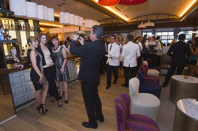 Karie Hall, general manager of the Cromwell, is flanked by guests during the VIP grand opening of Giada, the first Giada De Laurentiis restaurant, on Monday, June 2, 2014, in the Cromwell. The restaurant opens to the public Tuesday.