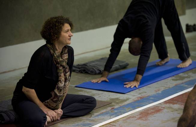 Yoga instructor, Iwona, left, leads inmates through Vinyasa yoga as Zack Pasillas, founder and outreach director with Yoga Seed Collective, demonstrates poses, on April 30, 2014, at the California State Prison in Sacramento, Calif.