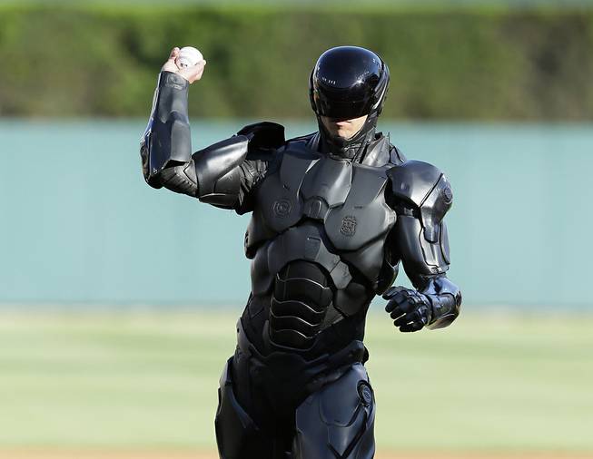 The movie character Robocop throws out a ceremonial first pitch before a baseball game between the Detroit Tigers and the Toronto Blue Jays in Detroit, Tuesday, June 3, 2014. 
