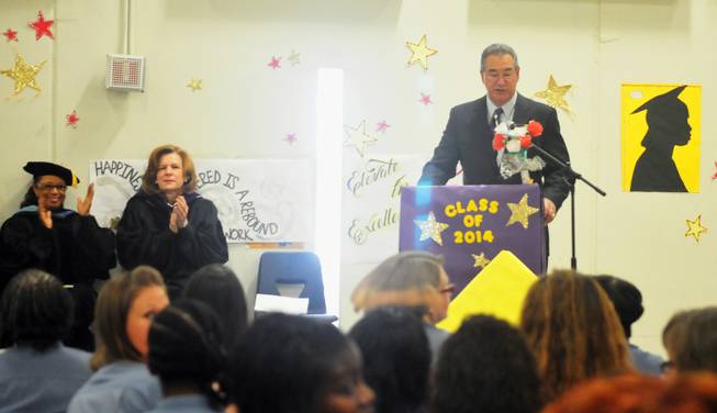 Principal Reid Kimoto addresses high school graduates at the Florence McClure Women's Correctional Center as School Board members Patrice Tew and Linda Young look on on Tuesday, June 3, 2014. The Clark County School District recognized more than 70 inmates who graduated from the district's adult education program with high school diplomas, GEDs and vocational certificates this year.