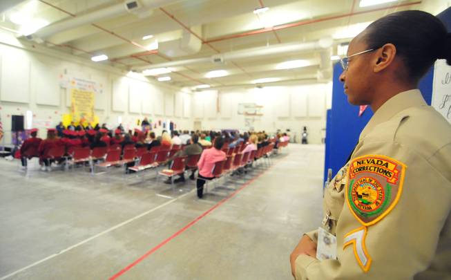 Correctional officer Vironica Banks looks on as the Clark County School District holds a graduation ceremony for more than 70 inmates at the Florence McClure Women's Correctional Center on Tuesday, June 3, 2014.