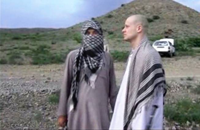 In this image taken from video obtained from Voice Of Jihad Website, which has been authenticated based on its contents and other AP reporting, Sgt. Bowe Bergdahl, right, stands with a Taliban fighter in eastern Afghanistan.