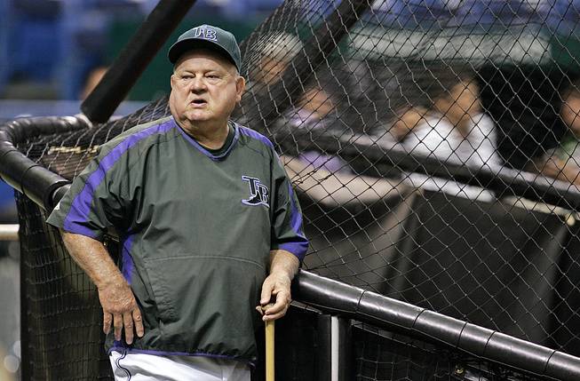 In this Sept. 21, 2007 file photo, Tampa Bay Devil Rays special adviser Don Zimmer leans against the batting cage before a baseball game between the Devil Rays and Boston Red Sox, in St. Petersburg, Fla. 