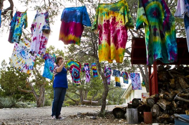Pitosi Pines director Tracey Brown hangs the dye shirts for drying created by attendees from Camp Vegas sponsored by the Nevada Diabetes Association Tuesday, April 15, 2014.