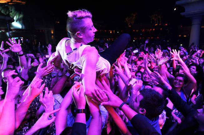 Macklemore crowd surfs during Surrender and Encore Beach Club’s fourth-anniversary ...
