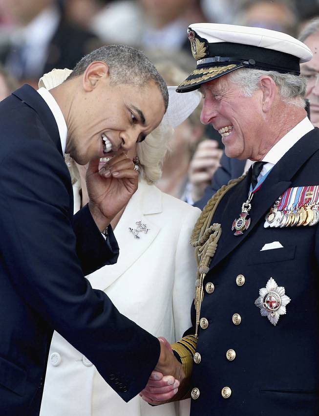 Britain's Prince Charles, right,  laughs as he meets U.S. President Barak Obama, during an International Ceremony with Heads of State at Sword Beach Ouistreham, France  to mark the 70th Anniversary of the D-Day landings Friday June 6, 2014. 