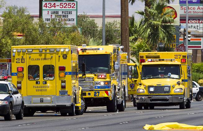 Clark County Fire Department rescue units stage on Nellis Boulevard Sunday, June 8, 2014. Two suspects shot two Metro Police officers in a nearby pizza shop then fled to the Wal-Mart where they shot and killed another person, police said. Both officers died of their injuries.