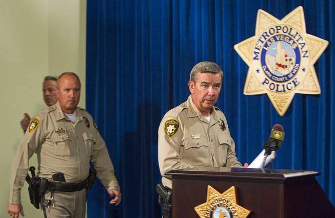 Clark County Sheriff Doug Gillespie, right, arrives for a news conference at Metro headquarters following the death of two officers and a citizen Sunday, June 8, 2014. Two suspects shot two Metro Police officers in a pizza shop then fled to a nearby Wal-Mart where they shot and killed another person, police said. The suspects are both dead.