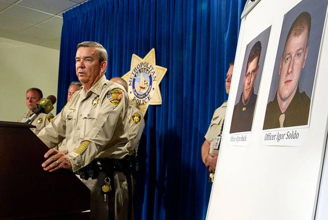 Clark County Sheriff Doug Gillespie speaks during a news conference at Metro headquarters following the death of two officers and a citizen Sunday, June 8, 2014. Two suspects shot two Metro Police officers, photos at right, in a pizza shop then fled to a nearby Wal-Mart where they shot and killed another person, police said. The suspects are both dead.
