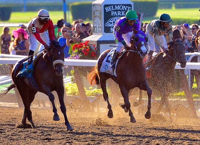 Victor Espinoza aboard California Chrome (2) rides past the finish line during the Belmont Stakes at Belmont Park, Saturday, June 7, 2014, in Elmont, N.Y. Tonalist went on to win the race, denying California Chrome the Triple Crown victory.