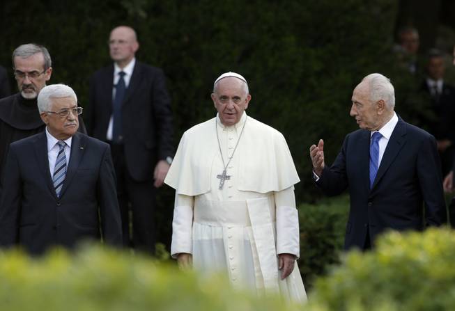 Pope Francis, Israel's President Shimon Peres, right, and Palestinian President Mahmoud Abbas, left, pray for peace at the Vatican on Sunday, June 8, 2014. Pope Francis waded head-first into Mideast peace-making Sunday, welcoming the Israeli and Palestinian presidents to the Vatican for an evening of peace prayers just weeks after the last round of U.S.-sponsored negotiations collapsed.