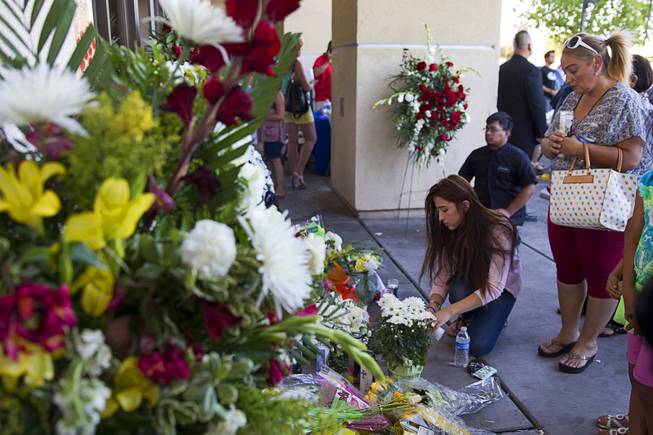 Natalie Vazquez, left, and her aunt Gina Avila light candles at a memorial in front of CiCi's Pizza, where two Metro Police officers were killed, during a community vigil Monday,, Nevada June 9, 2014. Police officers Alyn Beck, 41, and Igor Soldo, 31, were ambushed and killed in the restaurant while they were eating lunch on June 8.