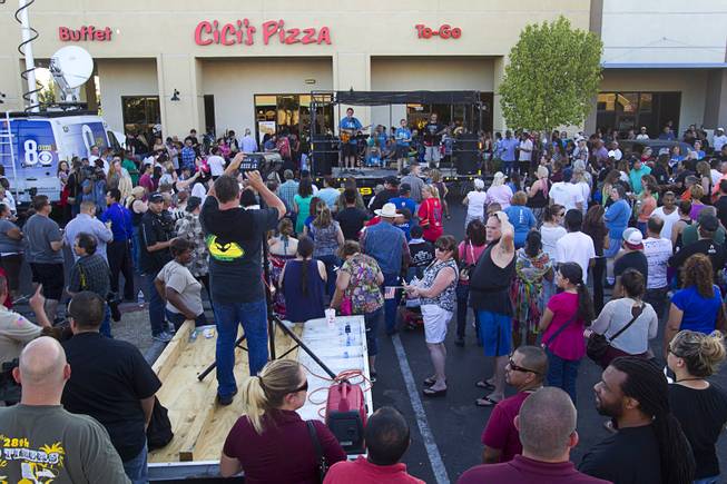 People attend a community vigil for slain Metro Police officers in front of CiCi's Pizza Monday,, Nevada June 9, 2014. Officers Alyn Beck, 41, and Igor Soldo, 31, were ambushed and killed in the restaurant while they were eating lunch on June 8.