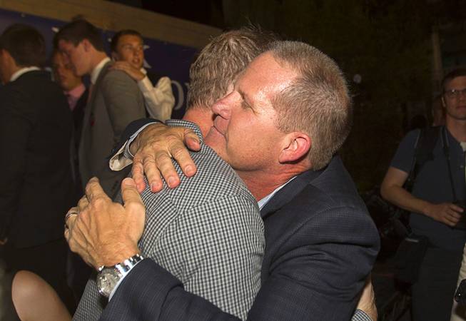 Mark Hutchison, right, Republican candidate for Lt. Governor, gets a hug from David McKeon, chairman of the Clark County Republican Party, during an primary election night party at Dom Demarco's Pizzeria Tuesday, June 10, 2014.