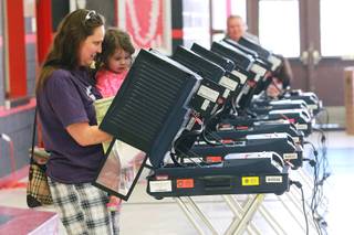 Rylynn Berkey assists her grandmother April Hiett as she casts her ballot at Las Vegas High Tuesday, June 10, 2014.