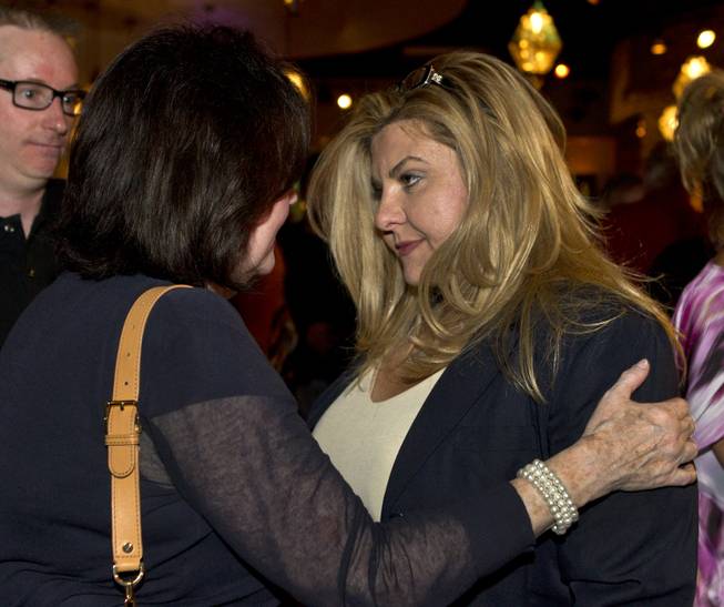 Assemblywoman Michele Fiore  is congratulated by Sue Lowden's  executive assistant Chris Hall as her race is going well during a Republican gathering at Mundo restaurant on Monday, June 9, 2014.