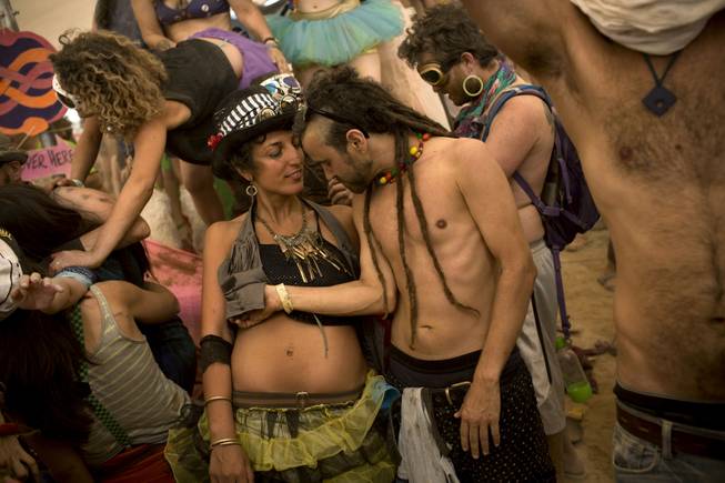 In this photo taken Thursday, June 5, 2014, Israelis dance at a party during Israelis first Midburn festival in the desert near the Israeli kibbutz of Sde Boker.