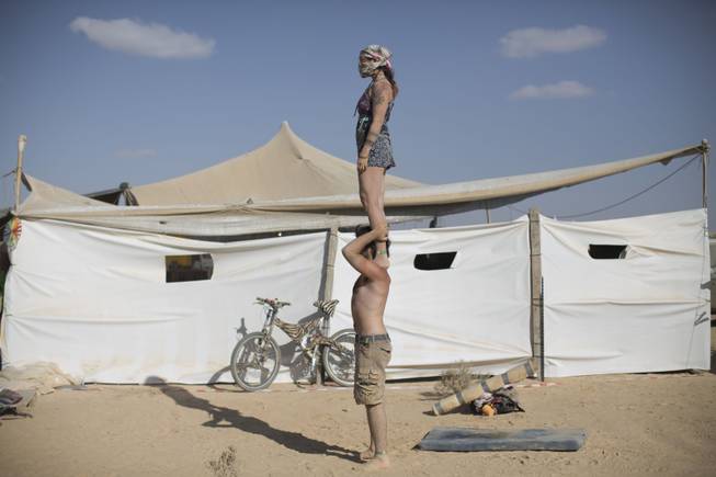 In this photo taken Friday, June 6, 2014, Israeli acrobats perform during Israelis first Midburn festival in the desert near the Israeli kibbutz of Sde Boker.