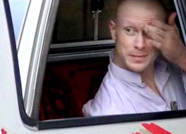 In this file image taken from video obtained from Voice Of Jihad Website, which has been authenticated based on its contents and other AP reporting, Sgt. Bowe Bergdahl, sits in a vehicle guarded by the Taliban in eastern Afghanistan.