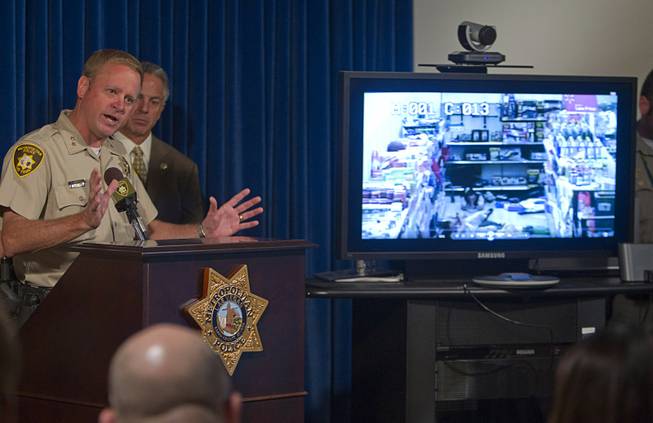 Assistant Sheriff Kevin McMahill speaks as Wal-Mart store surveillance video of shooting suspects is shown during a news conference at Metro Police headquarters Wednesday, June 11, 2014. Police provided new details on Sunday's shooting that resulted in five deaths, including two police officers and a civilian.