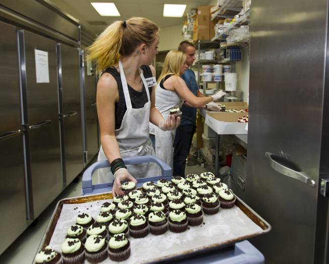 Workers and volunteers at Freed's Bakery of Las Vegas box up a few of the 35,000 cupcakes sold for $1 each with the proceeds going to aid the families of slain Metro Police Officers Alyn Beck and Igor Soldo on Wednesday, June 11, 2014.