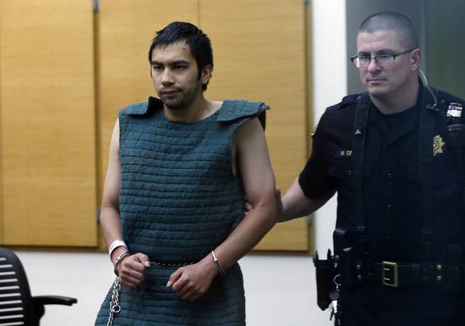 In this Friday, June 6, 2014, file photo, shooting suspect Aaron Ybarra, left, is led in chains to a court hearing at a King County Jail courtroom Friday, June 6, 2014, in Seattle, as he was arrested in the fatal shooting of a 19-year-old student and wounding of two other young people a day earlier at Seattle Pacific University. At a time when shootings seem to happen almost daily, how should Americans react if someone opens fire at work, at school or at a theater or store?