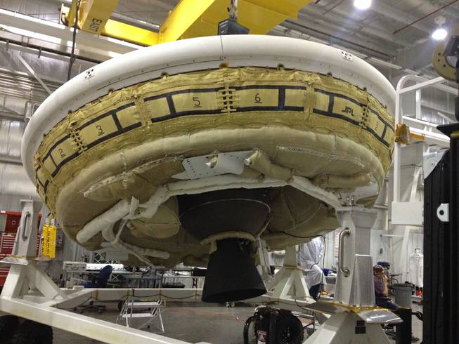 In this undated image provided by NASA a saucer-shaped test vehicle holding equipment for landing large payloads on Mars is shown in the Missile Assembly Building at the US Navy's Pacific Missile Range Facility in Kauai, Hawaii.