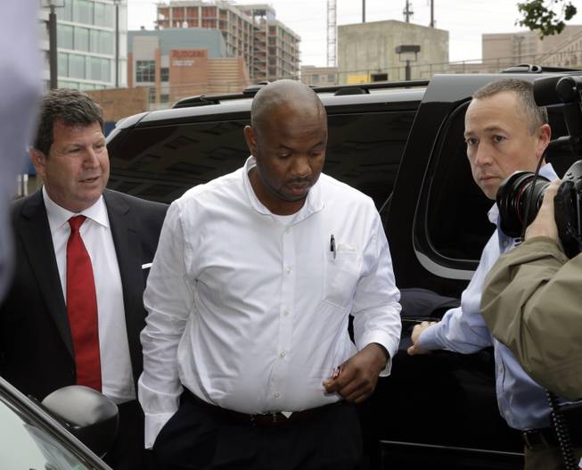 Kevin Roper, center, arrives with his attorney David Jay Glassman, left, for a court appearance Wednesday, June 11, 2014, in New Brunswick, N.J. Roper, a Wal-Mart truck driver from Georgia, was charged with death by auto and four counts of assault by auto in the wake of a deadly chain-reaction crash on the New Jersey Turnpike early Saturday, June 7, 2014, that killed comedian James McNair and left actor-comedian Tracy Morgan and two others critically injured.