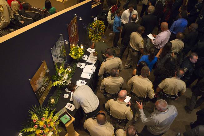 Metro Police officers and family members arrive for Metro Police officer Igor Soldo's funeral services at Canyon Ridge Church Thursday, June 12, 2014. Soldo and Metro Police Officer Alyn Beck where ambushed and killed by Jerad and Amanda Miller while eating lunch on Sunday, June 8.