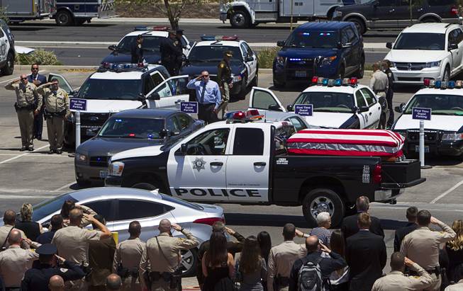 A truck with the casket of Metro Police officer Igor Soldo leaves for Palm Mortuary following a funeral service at Canyon Ridge Church Thursday, June 12, 2014. Soldo and Metro Police Officer Alyn Beck where ambushed and killed by Jerad and Amanda Miller while eating lunch on Sunday, June 8.