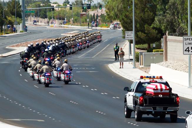 Law enforcement officers lead a Metro truck carrying the body of officer Igor Soldo to Canyon Ridge Church for Thursday, June 12, 2014.