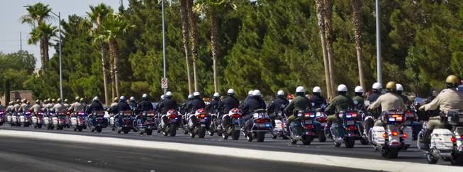 Metro Police Motorcycle Officers and other department officers lead a funeral procession for slain Metro Officer Igor Soldo as it departs from the Palm Mortuary to the Canyon Ridge Church service on Thursday, June 12, 2014.