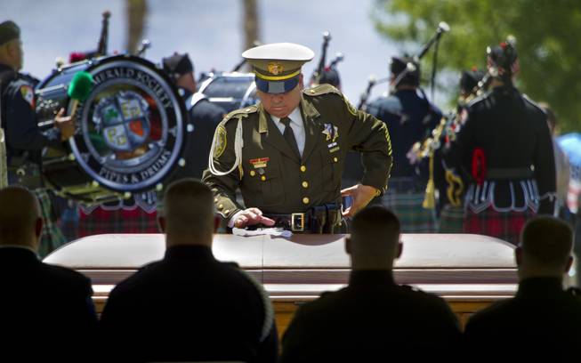 White gloves are securely placed atop the casket of slain Metro Officer Igor Soldo during funeral services at the Palm Mortuary on Thursday, June 12, 2014.