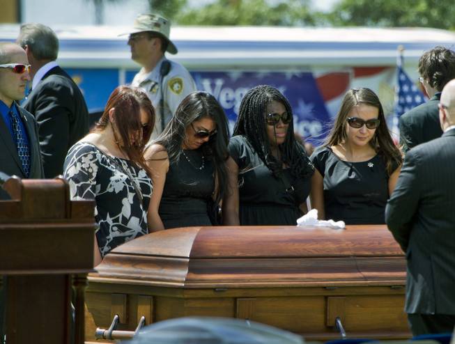 The casket of slain Metro Officer Igor Soldo is visited by those closest to him following funeral services at the Palm Mortuary on Thursday, June 12, 2014.