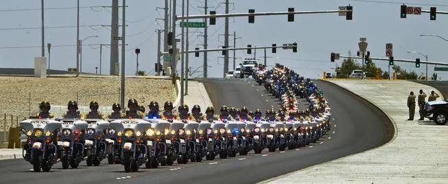 Metro Motorcycle Officers are joined by those from other area departments as they lead the body of slain Metro Officer Igor Soldo to the Palm Mortuary for funeral services on Thursday, June 12, 2014.