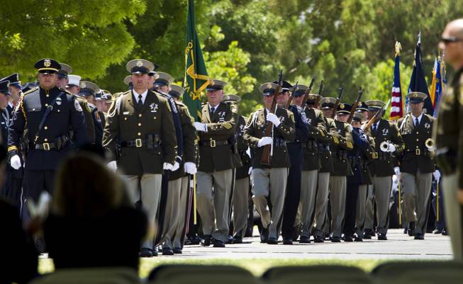 Color guards, rifle detail and buglers march into place during funeral services for slain Metro Officer Igor Soldo at the Palm Mortuary on Thursday, June 12, 2014.