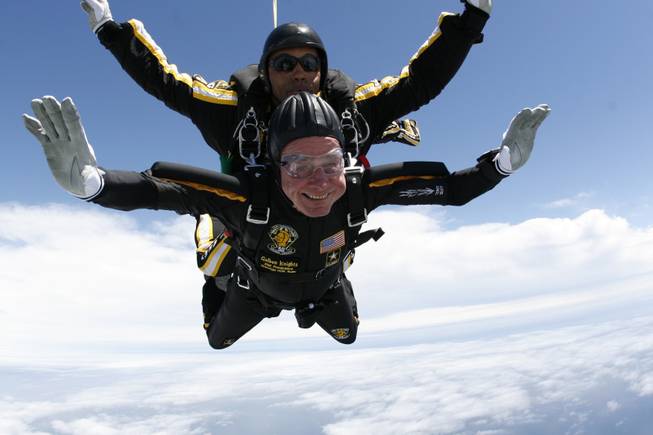 Former President George H. W. Bush rides tandem with Sgt. Michael Elliott of the Army Golden Knights parachute team as he celebrates his 85th birthday with a parachute jump, Friday, June 12, 2009, over Kennebunkport, Maine. Bush jumped again on his 90th birthday, June 12, 2014.