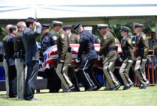 Police honor guard members carry the casket of Las Vegas police officer Igor Soldo for his funeral at Palm Northwest Mortuary & Cemetery on Thursday, June 12, 2014 in Las Vegas. Soldo, 31, and fellow officer, Alyn Beck, 41, were gun down by two assailants at a Cici's Pizza during their lunch break Sunday. Services for Beck are scheduled for Saturday. 