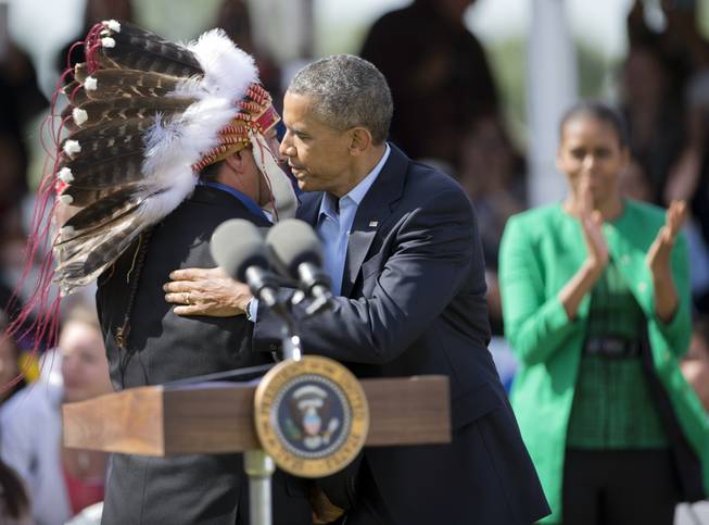 President Barack Obama with first lady Michelle Obama, Standing Rock Sioux Tribal Nation Chairman Dave Archambault II, in Cannon Ball, N.D., Friday, June 13, 2014, during a Cannon Ball flag day celebration, at the Cannon Ball powwow grounds. It’s the president’s first trip to Indian Country as president and only the third such visit by a sitting president in almost 80 years.