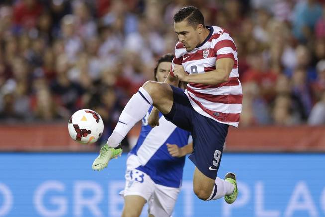The United States' Herculez Gomez, right, shoots on goal as Guatemala's Victor Hernandez, behind, defends in the second half during an international friendly soccer match Friday, July 5, 2013, in San Diego. 