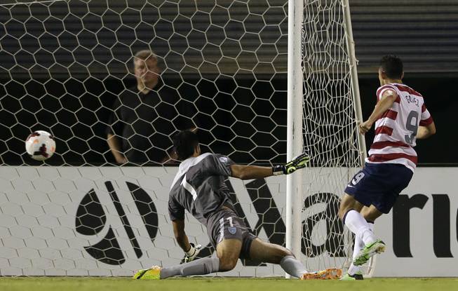 The United States' Herculez Gomez, right, scores as Guatemala goalkeeper Ricardo Jerez (1) watches the ball hit the net in the first half during an international friendly soccer match Friday, July 5, 2013, in San Diego. 