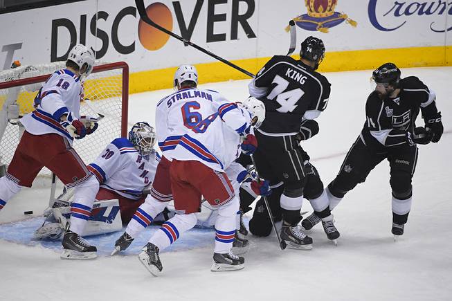 Los Angeles Kings right wing Justin Williams, right, watches as the puck enters the net, left, for a goal against the New York Rangers during the first period in Game 5 of the NHL Stanley Cup Final series Friday, June 13, 2014, in Los Angeles. 