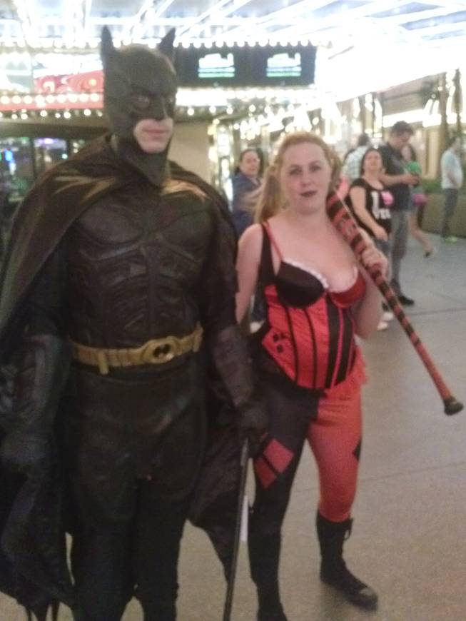 Jerad Miller dressed as Batman and wife Amanda Miller in a harlequin costume working on the Fremont Street Experience in early March 2014.