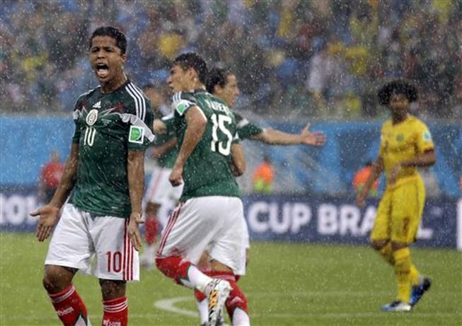 Mexico's Giovani dos Santos reacts after his goal was disallowed during the group A World Cup soccer match between Mexico and Cameroon in the Arena das Dunas in Natal, Brazil, Friday, June 13, 2014.