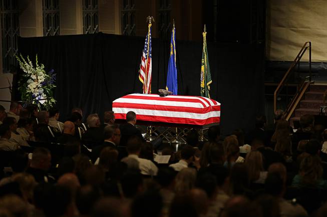 A flag covers the casket of Las Vegas Metropolitan Police Officer Alyn Beck during his memorial service at The Smith Center for the Performing Arts Saturday, June 14, 2014 in Las Vegas. Two suspects shot and killed Beck, 41, and fellow police officer Igor Soldo, 31, in an ambush at a Las Vegas restaurant Sunday, June 8, 2014, before fatally shooting a third person inside a nearby Wal-Mart, authorities said.